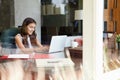 View Of Teenage Girl Using Laptop Through Window Royalty Free Stock Photo