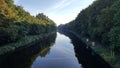 View of Teltow Canal surrounded by lush greenery. Berlin, Germany. Royalty Free Stock Photo