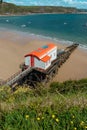 View from Tenby Wales UK of the coast and Carmarthen Bay in summer with old lifeboat station Royalty Free Stock Photo