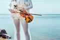 View Of Tender Woman In White Swan Costume With Violin Standing On Blue Sky And River Background