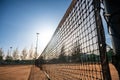 View of a tennis net adjusted across the court under the blue sky Royalty Free Stock Photo