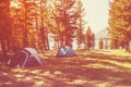 View of tent on meadow in forest at sunrise. Royalty Free Stock Photo