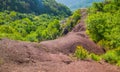 View of the `Terre Rosse` Red Lands a small area made up of rocks and red clay, where the vegetation struggles to grow, forming