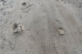 View of textured brown sand with human footprints