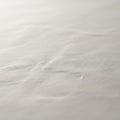 View of a textured white surface, possibly paper or fabric, exhibiting Royalty Free Stock Photo