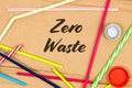 Colorful Plastic straws on a cardboard background and the inscription `Zero Waste` The concept of a lifestyle based on awareness o