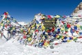Thorong La sign with prayer flags at the highest point of the pass Annapurna Circuit Nepal