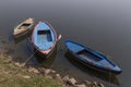 Three boats at coast of Ganges river in Varanasi city Royalty Free Stock Photo