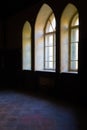 View of three neo-gothic windows with beautiful wooden frames in the interior of a dark room in Sharovsky castle, Royalty Free Stock Photo