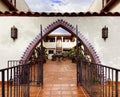 view through three-pointed arch doorway into courtyard