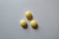 View of 3 round yellow pills of xylitol from above