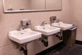 View at three white sink in a men`s restroom Royalty Free Stock Photo