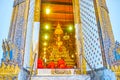 The view throught the doors in Phra Ubosot temple, Wat pho complex in Bangkok, Thailand