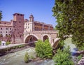 A view of Tiber island, bridge Fabricio and Caetani fortress tower over Tiber river. Royalty Free Stock Photo
