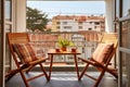 view of a tidy shared balcony with two different style chairs Royalty Free Stock Photo