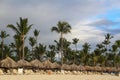 View of tiki umbrellas and lounge chairs at a beach at the Dominican Republic