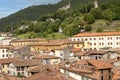 View of the tiled roofs, mountains covered with trees in the town of Lovere, Lake Iseo, Italy Royalty Free Stock Photo