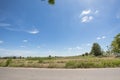 View of tillage rice field and the road with blue sky background and afternoon sunlight at lampoon thailand Royalty Free Stock Photo