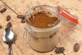 Tiramisu in a pot on a wooden table