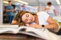 View on tired young Latina female student sleeping