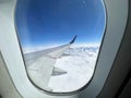 View to the aircraft wing from the window inside the plane Royalty Free Stock Photo