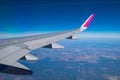 View to Airplane wing out of porthole window. Royalty Free Stock Photo