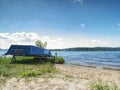 View to anchored laminate blue rowing boat at large lake Royalty Free Stock Photo