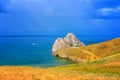 View to Baikal lake with Burkhan cape and Shamanka rock at Olkhon island in approaching thunderstorm. Beautiful summer landscape