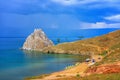 View to Baikal lake with Burkhan cape and Shamanka rock at Olkhon island in approaching thunderstorm. Beautiful summer landscape