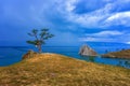 View to Baikal lake with Burkhan cape and Shamanka rock at Olkhon island in approaching thunderstorm. Beautiful summer landscape