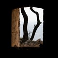 View of to big bare trees through a stone window in Fort Royal on Lokrum Island. Dubrovnik, Croatia Royalty Free Stock Photo