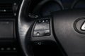 View to the black interior of Lexus RX450h Hybrid with dashboard, steering wheel control buttons of music and audio system