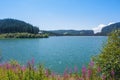 A view to Bolboci lake and the damb with carpathian mountains at