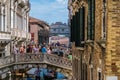View to bridge of sighs in Venice, Italy. Crowds of tourists crossing the bridge at Doges Palace