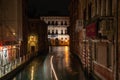 View to the Ca Pesaro International Museum of Modern Art at Night, a Boat driving on the rio di San Falice, Venice Royalty Free Stock Photo