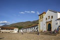 View to the Church of our Lady of the Rosary and historical buildings at Plaza Mayor of Villa de Leyva, against blue sky,