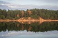 View to autumn forest in Ogre Zilie Kalni Blue Hill Nature Park over Dubkalni Reservoir with beautiful reflections in the water