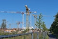 View to cranes on a construction site where new residential buildings are being built Royalty Free Stock Photo