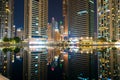 View to Dubai Marina skyscrapers from Jumeirah Lakes Towers. Beautiful illumination of buildings with colorful lights.