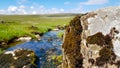 A view to English landscape with blurred backspace with brook stones under blue sky and clouds Royalty Free Stock Photo