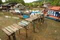 View to the fishermen`s village with stilt residential houses and fishing boats at low tide in Koh Chang, Thailand. Royalty Free Stock Photo