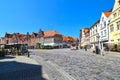 View to the German medieval town of Lueneburg. You see the marketplace with facades of bricks and small shops with tourists