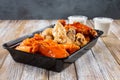 plastic container of assorted chicken wings, wing sampler Royalty Free Stock Photo