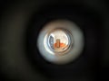 View to the hall through peephole eyelet in the door.