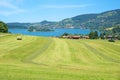 View to lake schliersee and health resort, from Neuhaus. beautiful bavarian landscape with hay field in the front Royalty Free Stock Photo