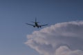 View to landing passenger jet with cloudy sky at munich