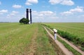 view to lighthouse in field with farm road under blue sky in Ukraine Royalty Free Stock Photo