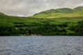 A view to Loch Tay lodges village taken from the rental boat in a lake, central Scotland Royalty Free Stock Photo