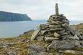 View to the Mageroya Cape and sea with the stack of stones at the fore ground in North Cape, norway.