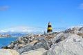 A view to Mediterranean sea, a lighthouse with breakwaters, fishing rods of locals and Torremolinos at the background from a pier Royalty Free Stock Photo